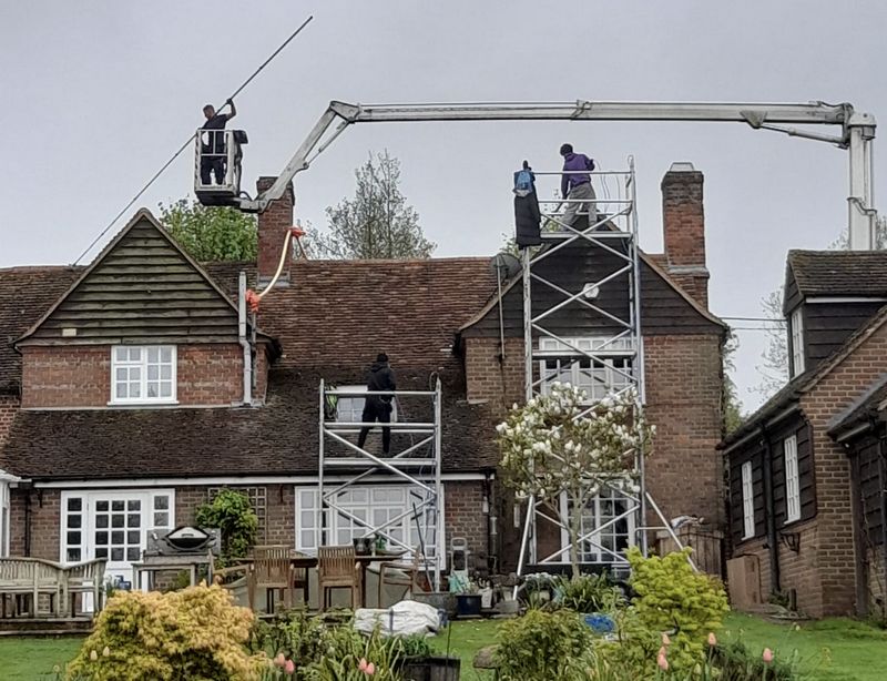 The Moss Cleaners using cherry picker and scaffolding to clean roof safely and professionally in East Wittering, West Sussex